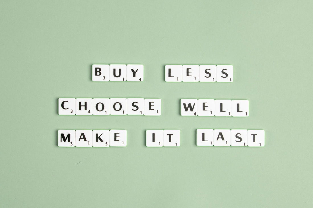 Sentence "Buy less, choose well, make it last" built with Scrabbler letters on a light green background