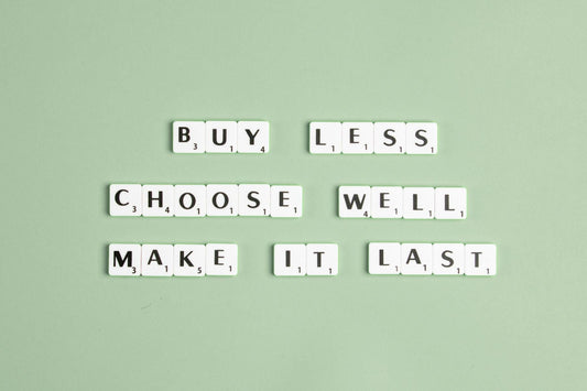 Motivational quote 'Buy Less, Choose Well, Make It Last' built with Scrabbler letters on a light green background