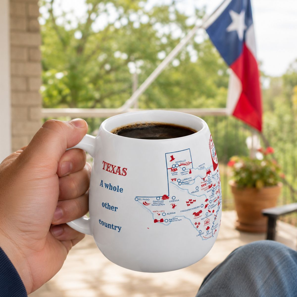 Person holding a Texas mug outdoors on a porch, featuring a Texas flag in the background.
