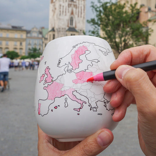 Colouring in Poland using a pastel pink ceramic pen on the Europe mug with Krakow main square in the background