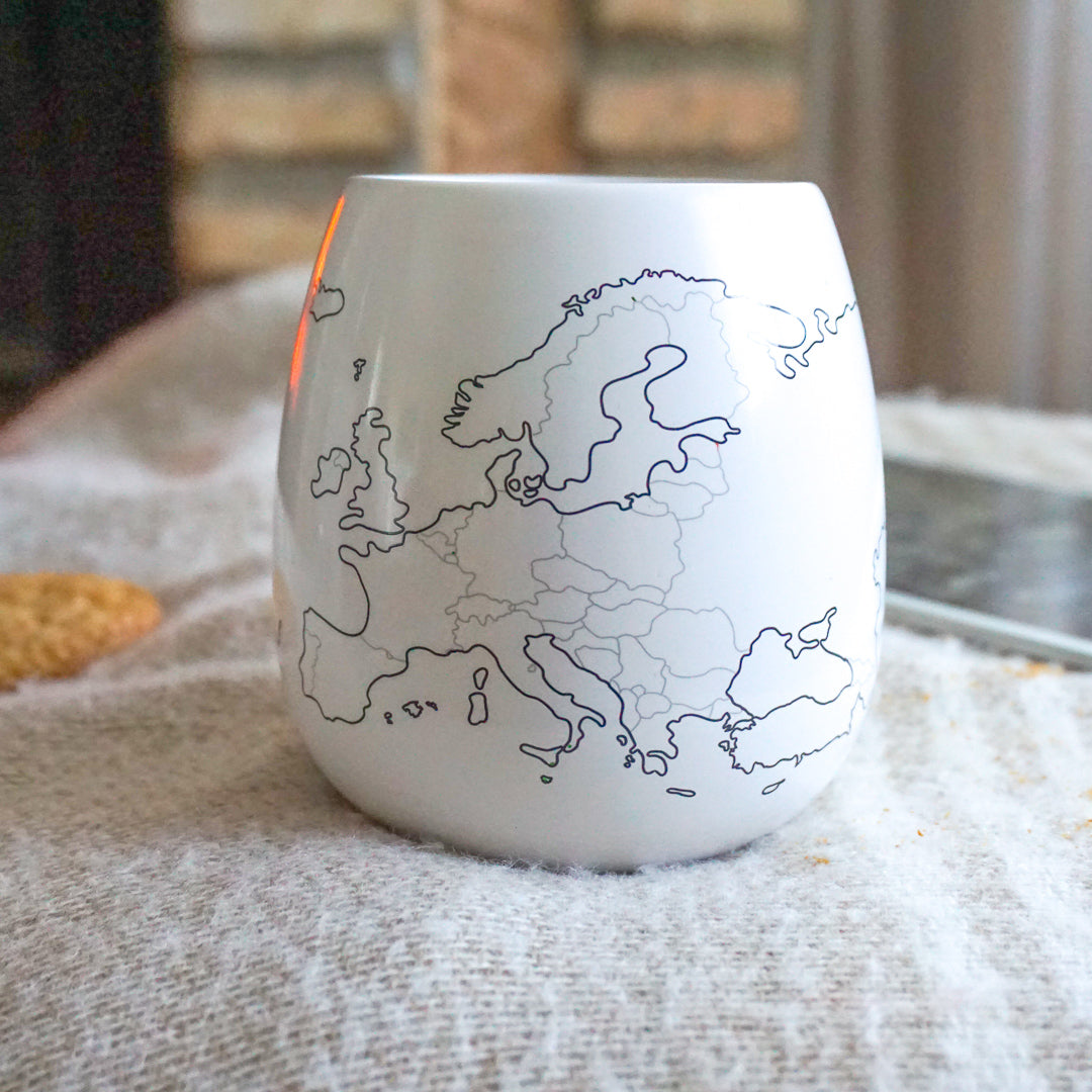 Uncoloured Europe map mug in cosy home setting to plan future European trips, bucket list mug
