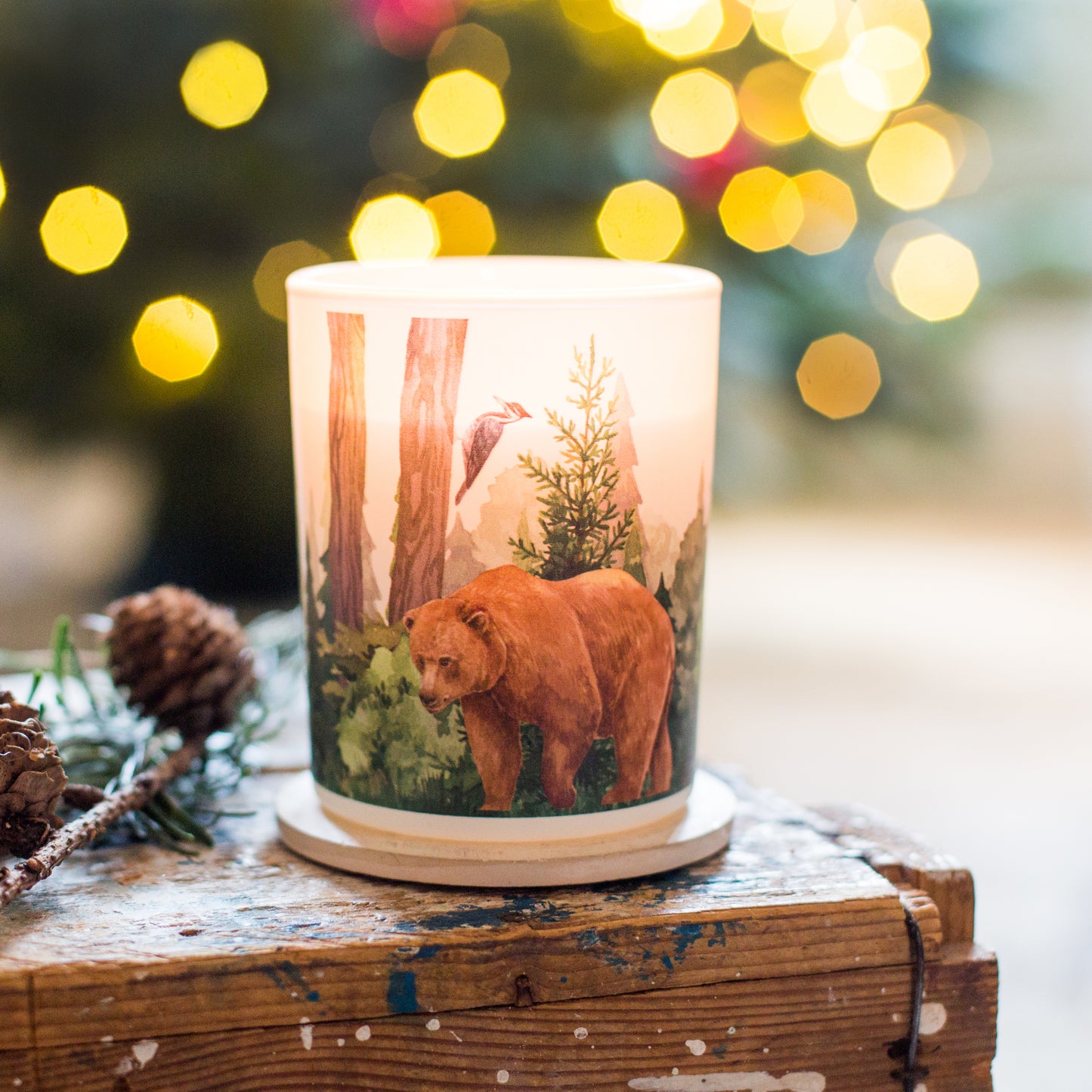 Lit forest balsam fir and wild berries soy candle creating a warm woodland atmosphere, sustainable eco-friendly Christmas gift.