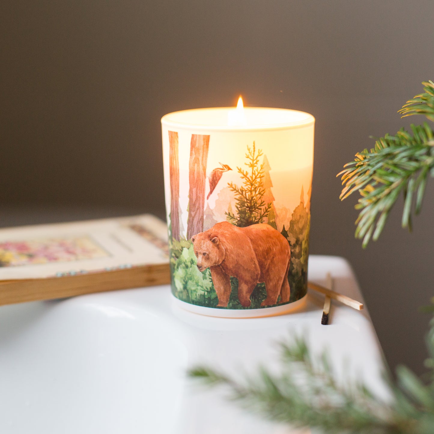 Forest soy scented candle with balsam fir and wild berries fragrance, featuring a hand-illustrated woodland design with a bear and a woodpecker, sustainable eco-friendly gift.