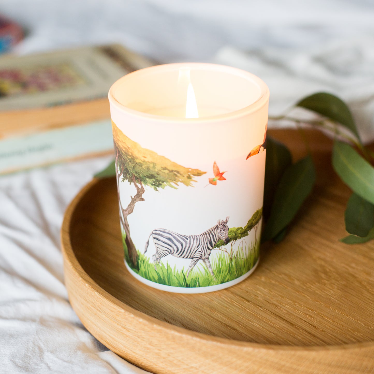 Lit Grassland soy candle with fresh citrus and sweet grass notes, creating an uplifting atmosphere. A sustainable home fragrance gift.