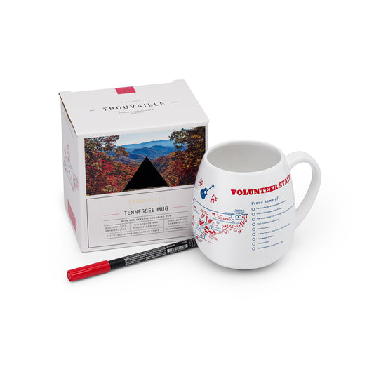 A white ceramic travel mug with a Tennessee map design, accompanied by a red ceramic pen and its packaging