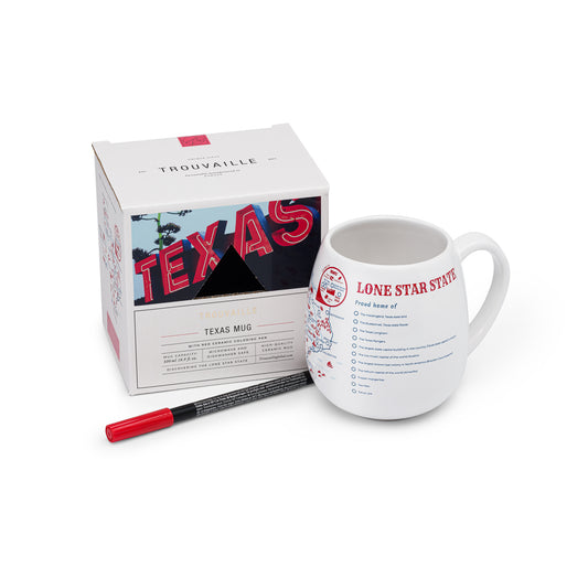 A white ceramic Texas travel mug along with a red ceramic marker and its packaging, road trip memory gift for Texas explorers