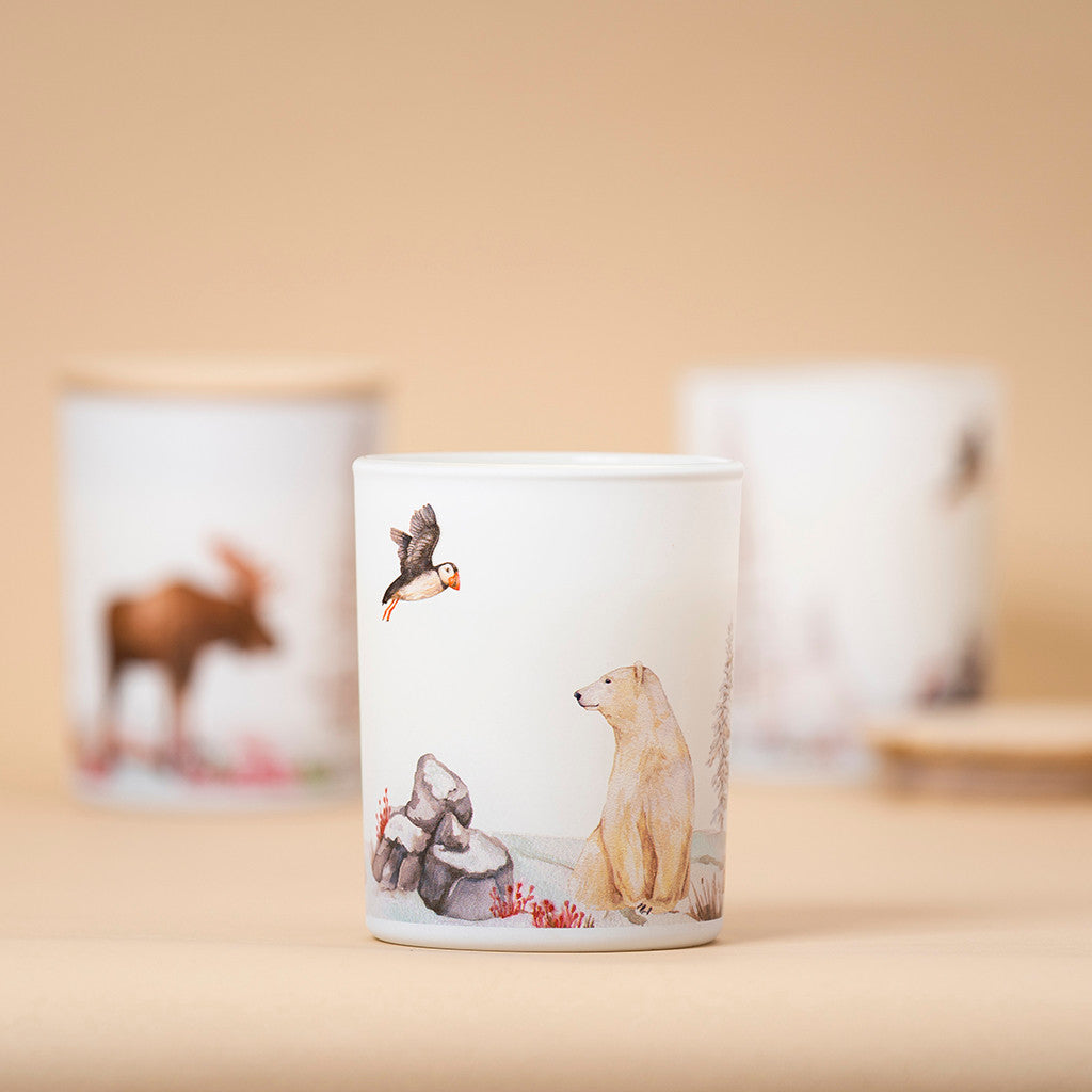 Tundra soy candle featuring a 360-degree wildlife illustration with a polar bear and a puffin, inspired by wild Nothern landscapes.