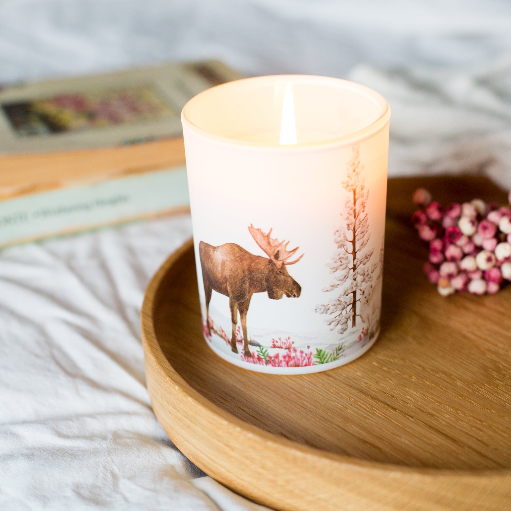 Lit Tundra soy candle styled on a wooden tray, inspired by Arctic landscapes. A calming sustainable home fragrance gift for winter nights.